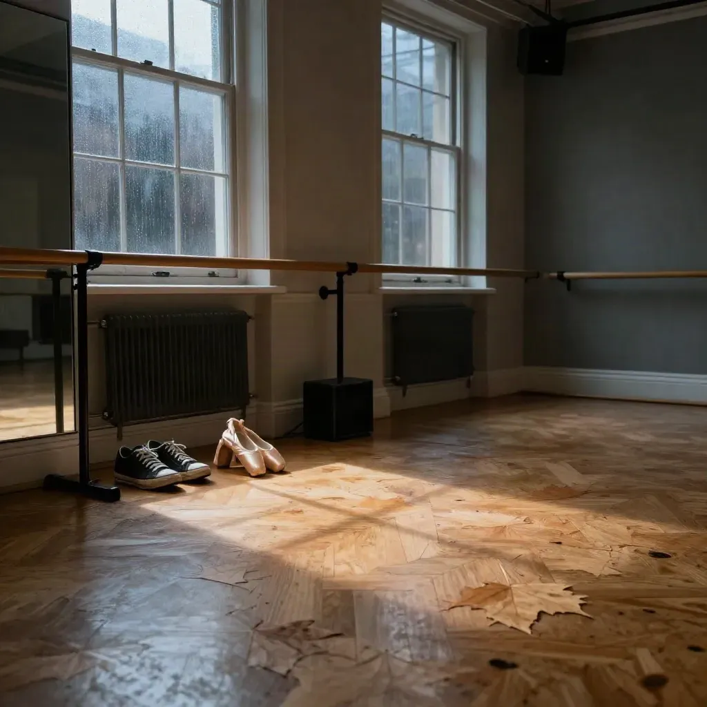 Empty dance studio with shoes, barre, mirror and warm raking light after rain